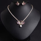 Elegant Svanhalsband och Örhängen med Rosa/Lila Stenar